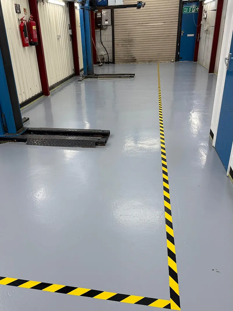 Clean workshop floor and vehicle lift at Raimondi Auto Services Old Woking